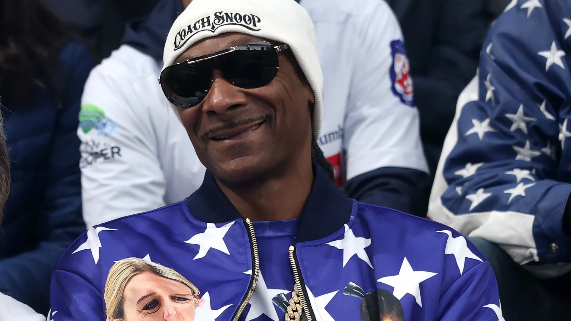 Snoop Dogg smiles as he watches the Curling Mixed Doubles Round Robin match at the 2026 Winter Olympics (Source: Richard Heathcote/Getty Images)