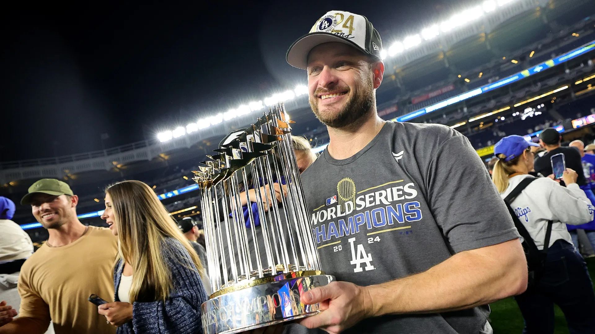 Ryan Brasier #57 with the Dodgers celebrates with the Commissioner’s Trophy. Alex Slitz/Getty Images