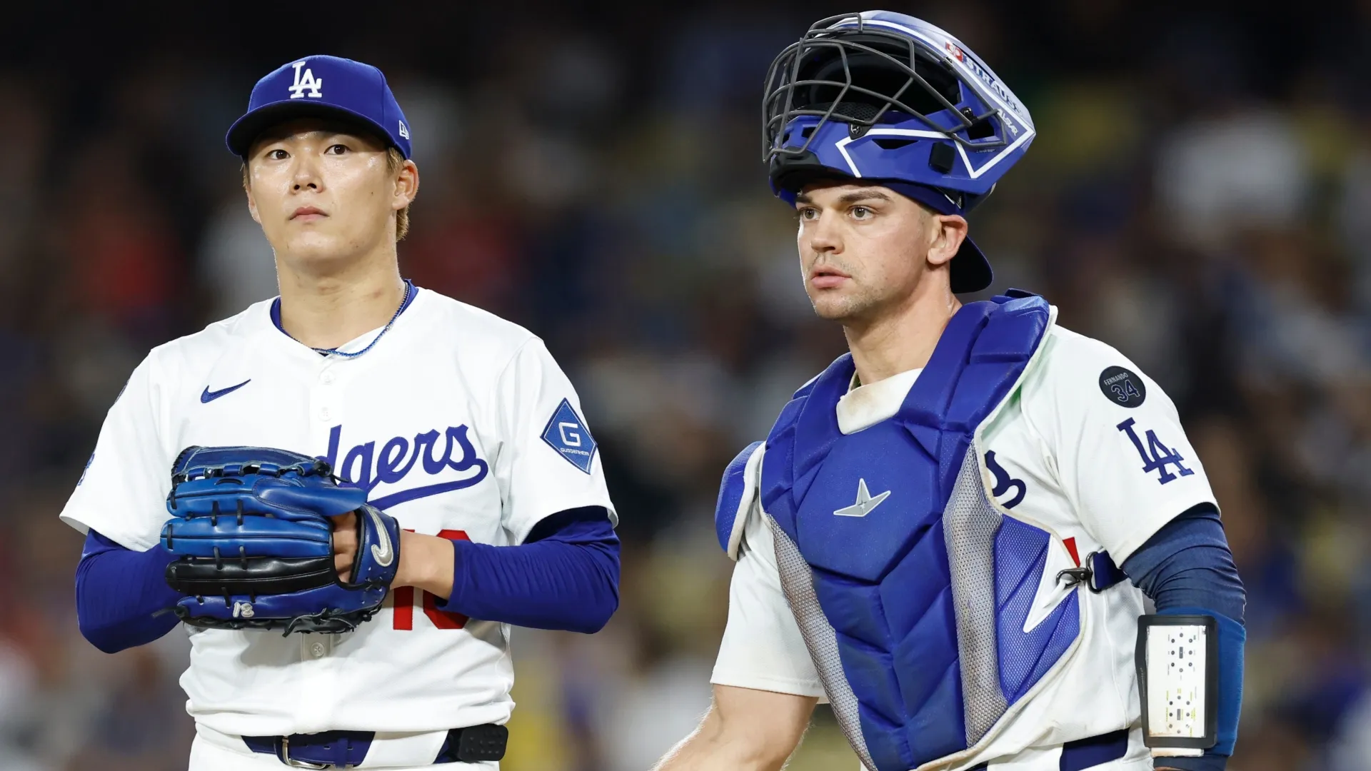 Yoshinobu Yamamoto #18 and Ben Rortvedt #47 of the Dodgers meet on the mound. Ronald Martinez/Getty Images