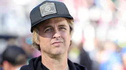 Billie Joe Armstrong of Green Day looks on from the field before Super Bowl LX.