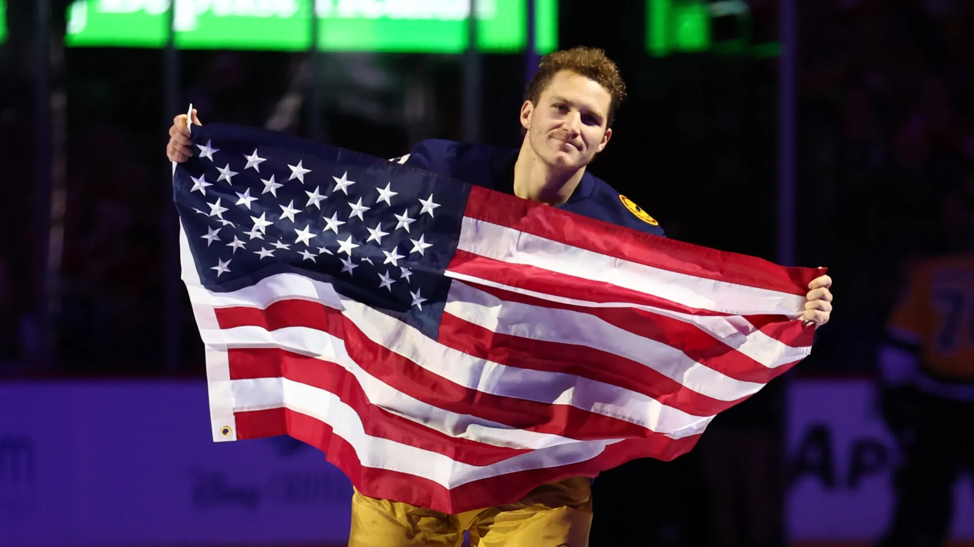 Matthew Tkachuk skates with an American flag
