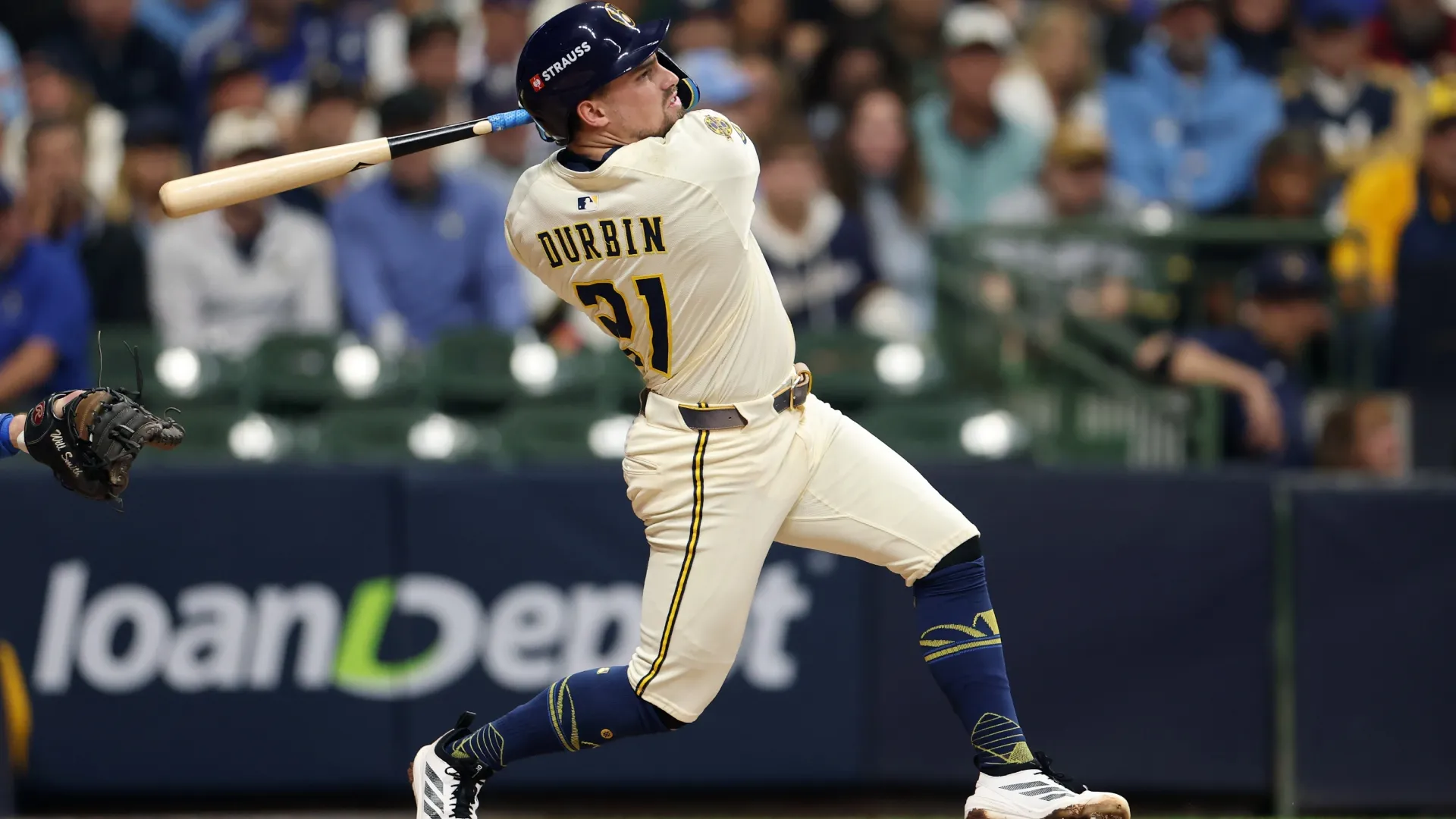 Caleb Durbin #21 with the Brewers hits a single. Michael Reaves/Getty Images