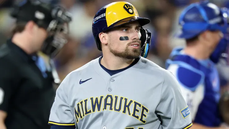 Caleb Durbin #21 with the Brewers walks back to the dugout.