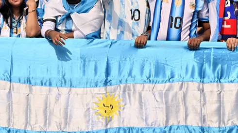 Fans of Argentina cheer with a flag