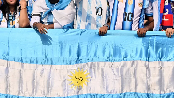 Fans of Argentina cheer with a flag