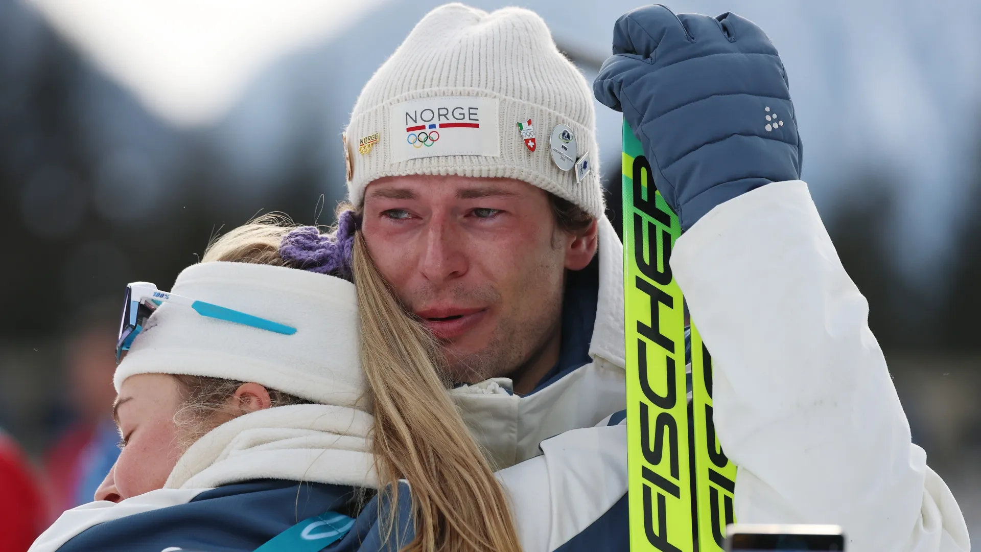 Sturla Holm Laegreid embraced by Ingrid Landmark Tandrevold after the medal ceremony (Source: Harry How/Getty Images)