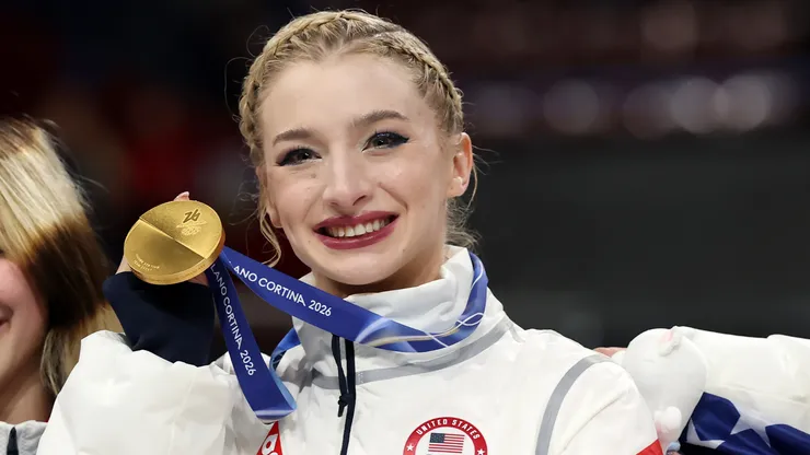 Amber Glenn poses with a gold medal.
