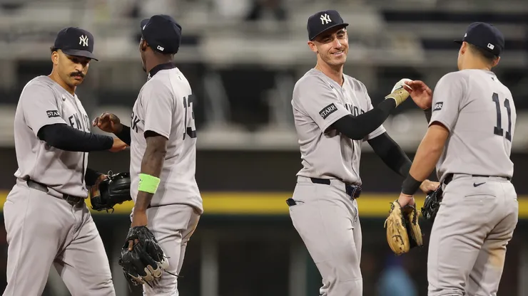 Trent Grisham #12, Jazz Chisholm Jr. #13, Cody Bellinger #35 and Anthony Volpe #11 of the New York Yankees celebrate.