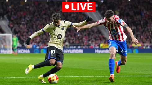  Lamine Yamal of FC Barcelona crosses the ball whilst under pressure from Matteo Ruggeri of Atletico de Madrid.
