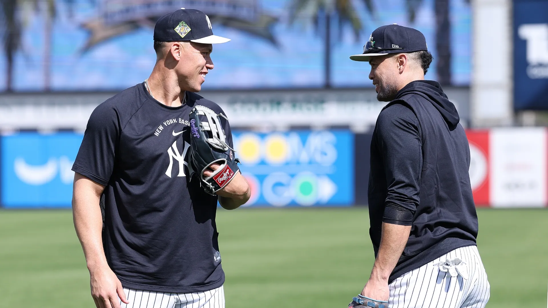 Aaron Judge #99 and Giancarlo Stanton #27 of the New York Yankees converse during team workouts. Kevin C. Cox/Getty Images