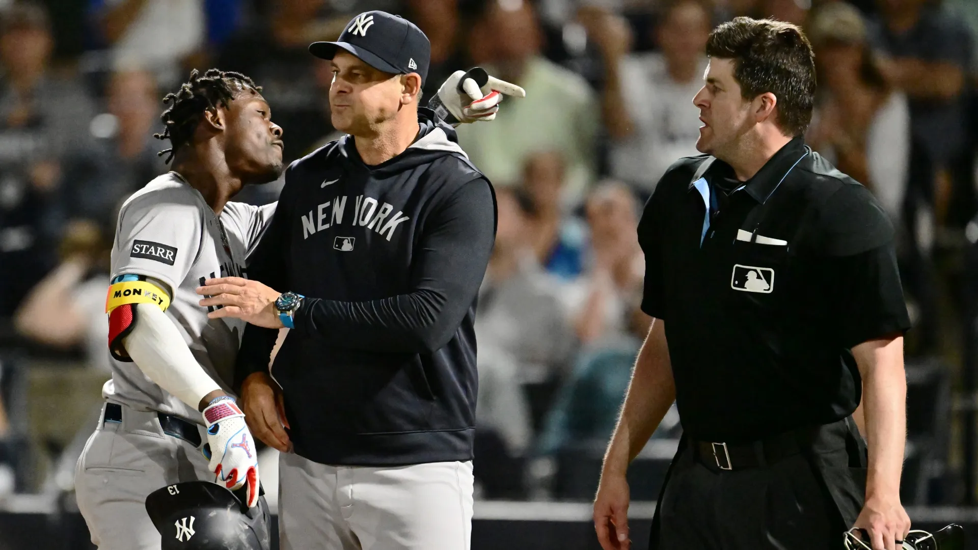 Jazz Chisholm Jr. #13 of the Yankees is held back by manager Aaron Boone. Julio Aguilar/Getty Images