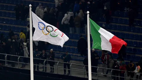 The Olympic flag is seen alongside the Italian flag during the opening ceremony of the Milano Cortina 2026 Winter Olympics.