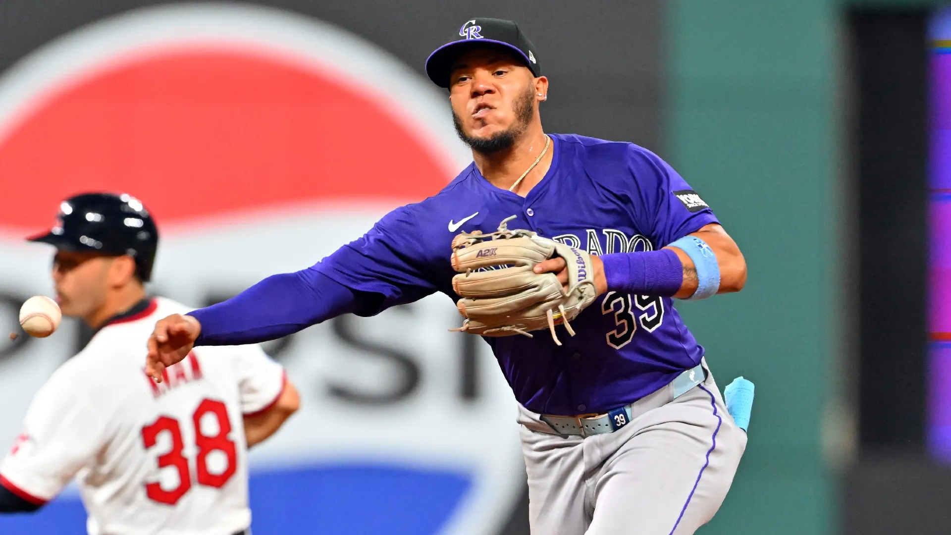 Thairo Estrada #39 of the Rockies throws to first base. Jason Miller/Getty Images