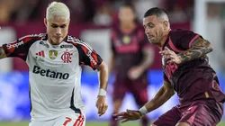 Luiz Araujo of Flamengo controls the ball against Ramiro Carrera of Lanus