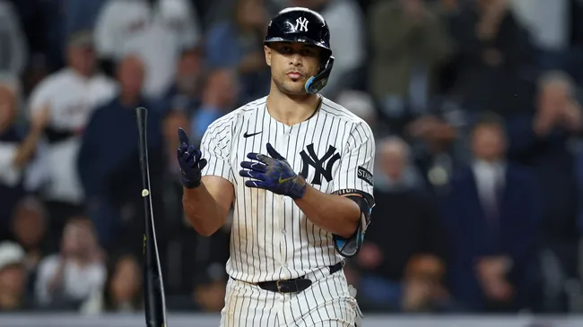 Giancarlo Stanton #27 of the Yankees tosses his bat after drawing a walk. Ishika Samant/Getty Images