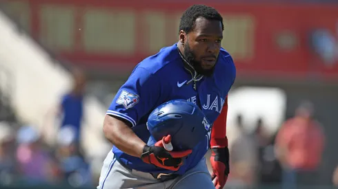 Vladimir Guerrero Jr. of the Blue Jays loses his helmet while running to first base during a spring training game.
