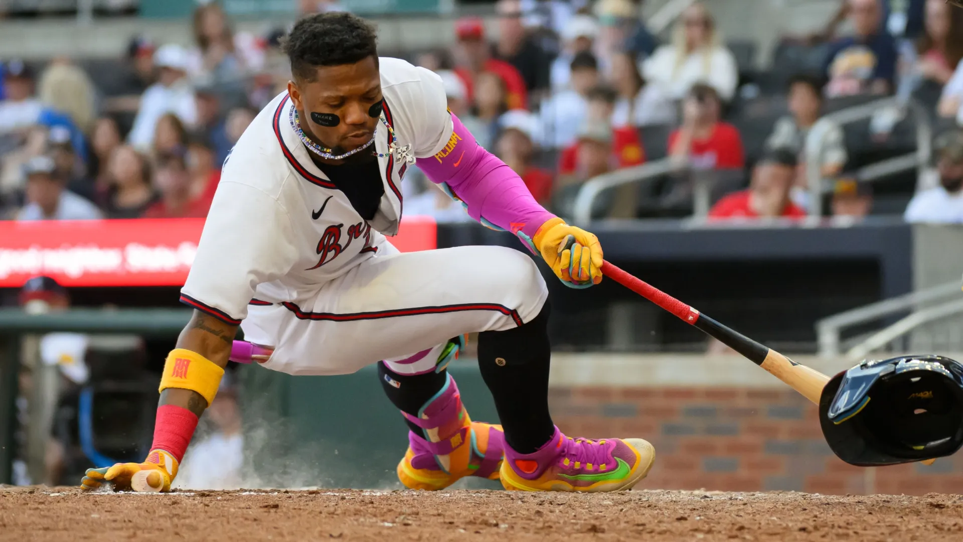 Ronald Acuña Jr. #13 of the Braves gets spun around by a high inside pitch for a walk. Edward M. Pio Roda/Getty Images