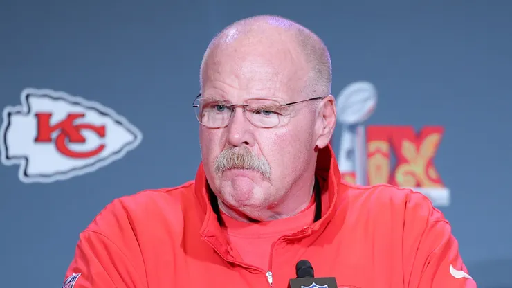 Andy Reid listens to a question at a press conference.