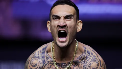 Max Holloway stands on the scale