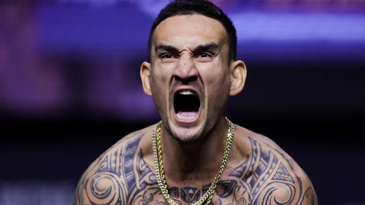 Max Holloway stands on the scale