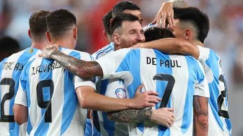 Lionel Messi of Argentina celebrates with teammates after scoring a goal.