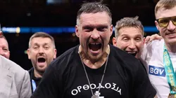 Oleksandr Usyk poses for a photo with the title belts after victory over Daniel Dubois.