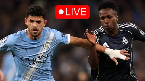 Matheus Nunes of Manchester City battles for possession with Vinicius Junior of Real Madrid.