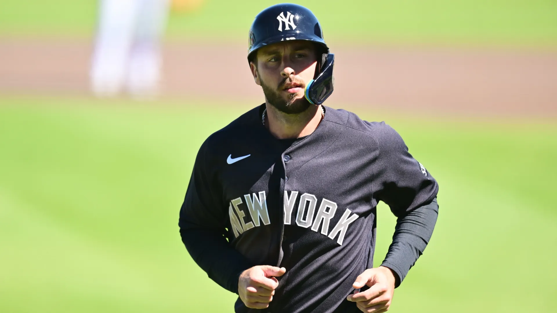 Paul DeJong #18 of the Yankees looks on after scoring vs. Brewers. Julio Aguilar/Getty Images