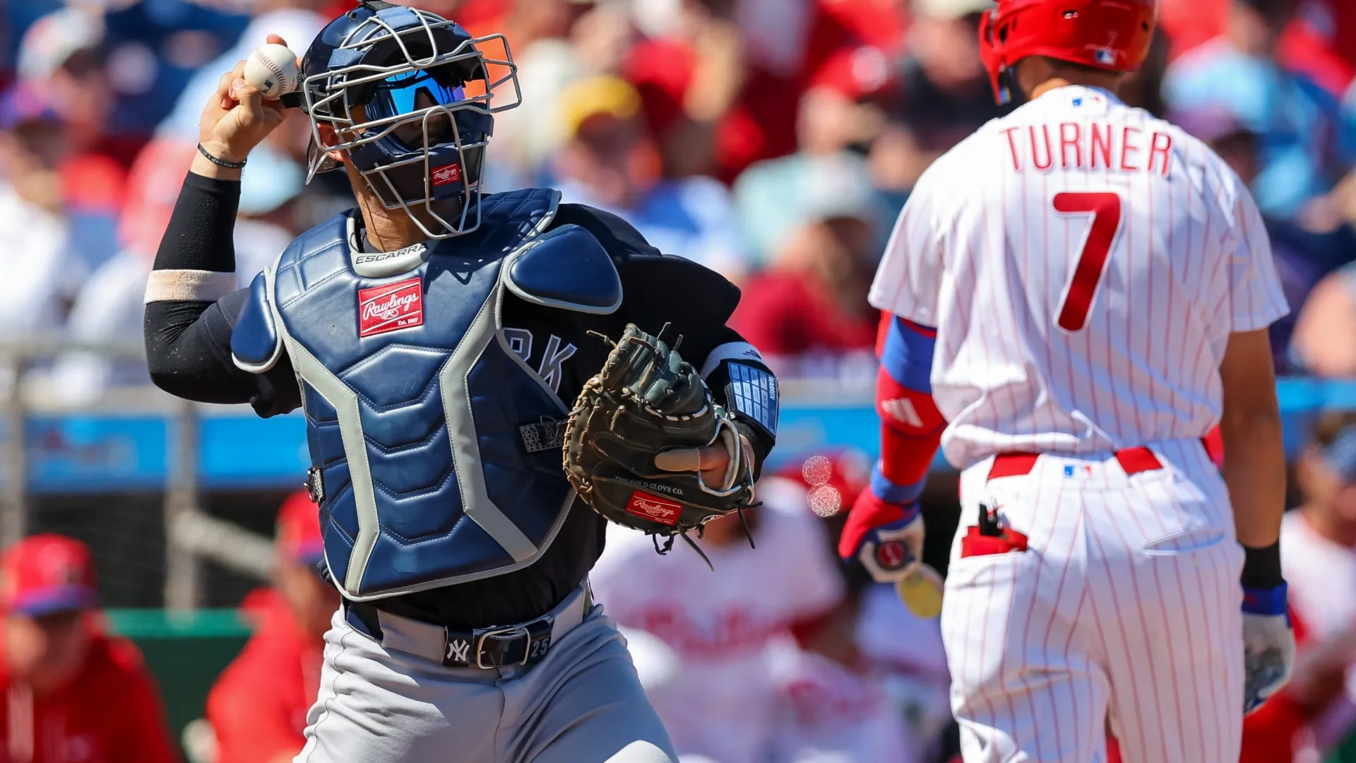 J.C. Escarra #25 of the Yankees throws the ball after a strikeout of Trea Turner. Mike Carlson/Getty Images