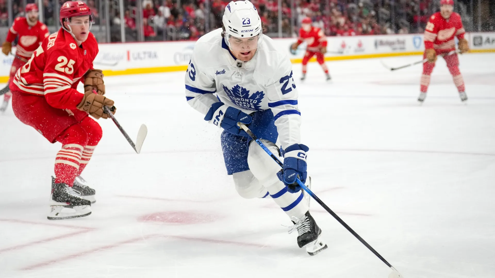 Matthew Knies #23 of the Maple Leafs skates with the puck against the Red Wings. Nic Antaya/Getty Images