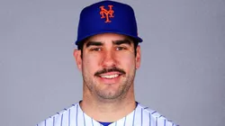 Mike Tauchman smiling with the New York Mets jersey.