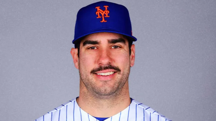 Mike Tauchman smiling with the New York Mets jersey.