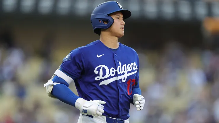 Shohei Ohtani #17 of the Los Angeles Dodgers runs to first.