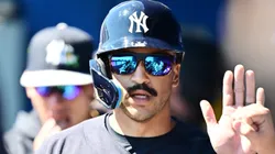 Trent Grisham #12 of the Yankees celebrates with teammates after scoring in the first inning.