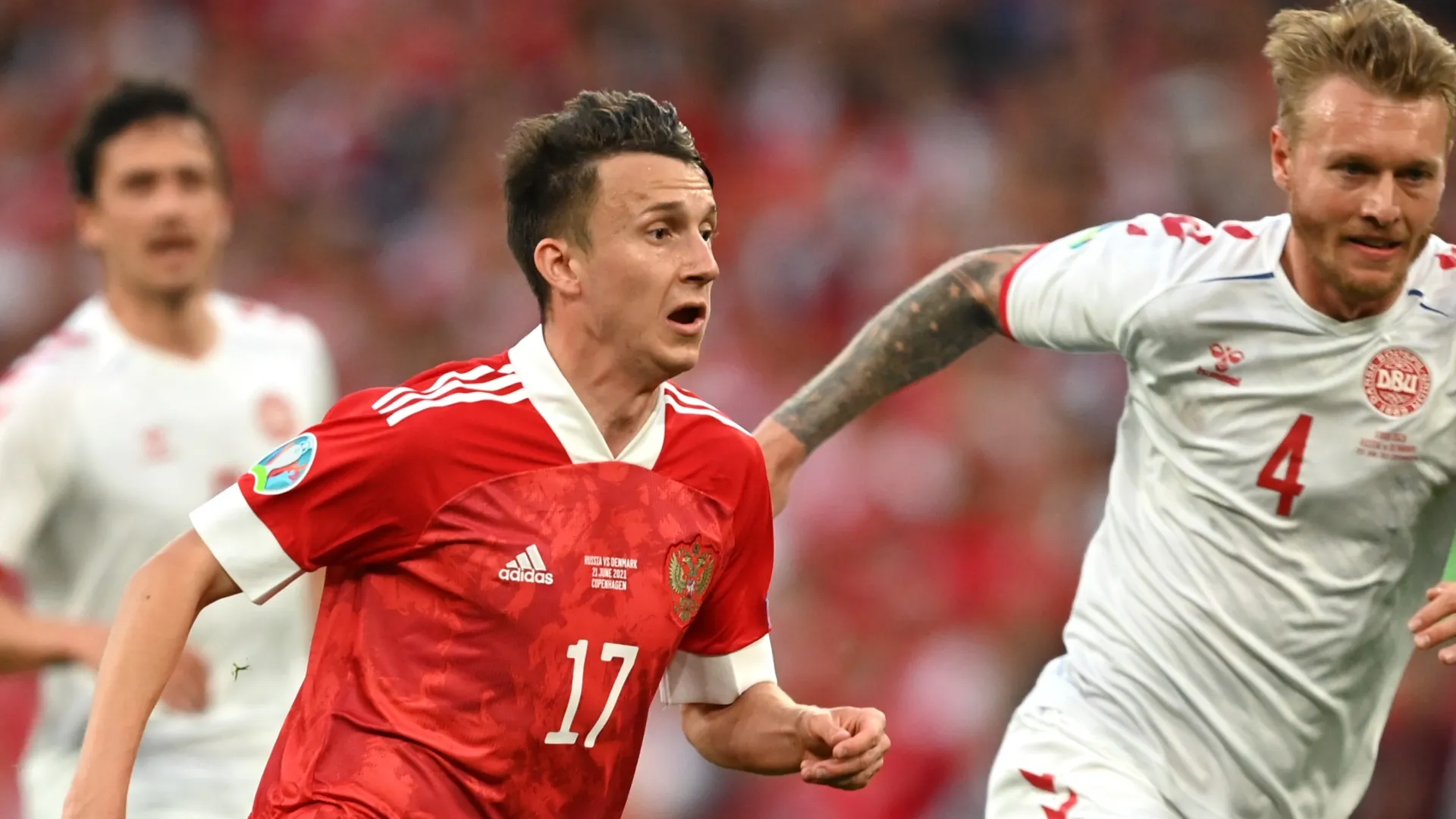 Aleksandr Golovin of Russia is challenged by Simon Kjaer of Denmark. Stuart Franklin/Getty Images