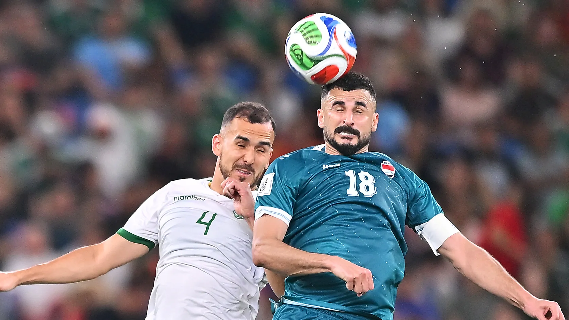 Aymen Hussein of Irak heads the ball against Luis Haquin of Bolivia.