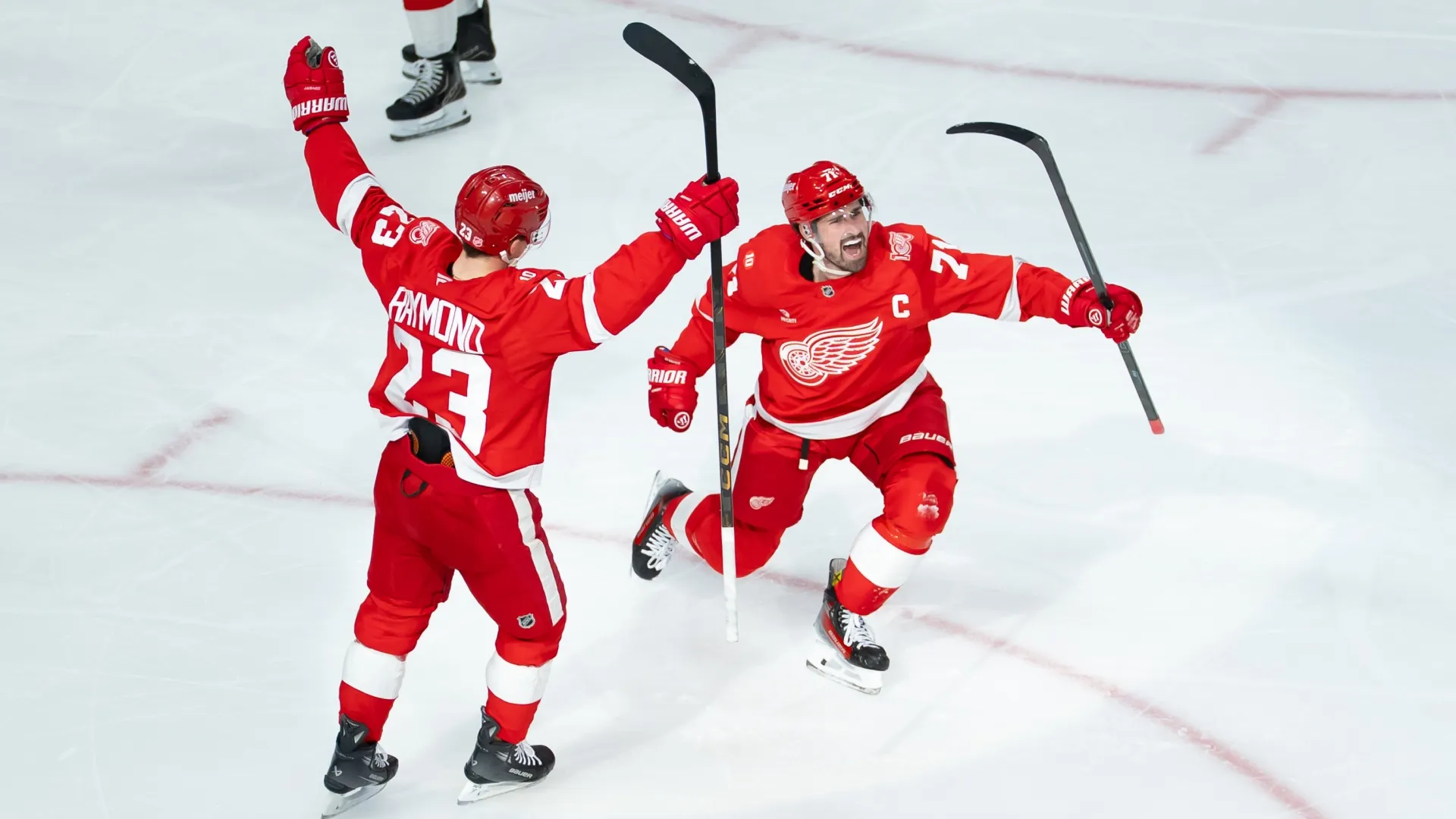 Dylan Larkin #71 of the Detroit Red Wings celebrates with Lucas Raymond #23 after scoring a goal. Jaime Crawford/Getty Images