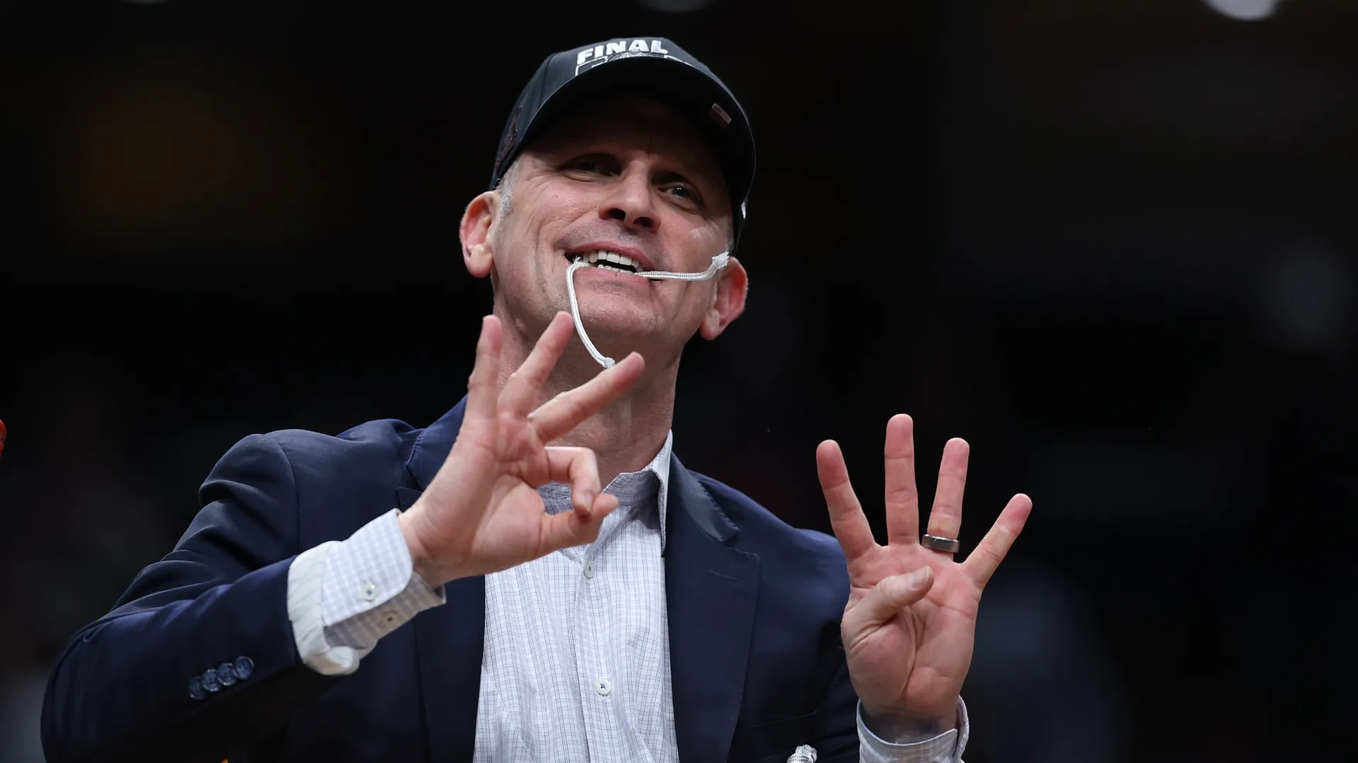 Dan Hurley cuts down the nets after UConn won NCAA East Region Tournament