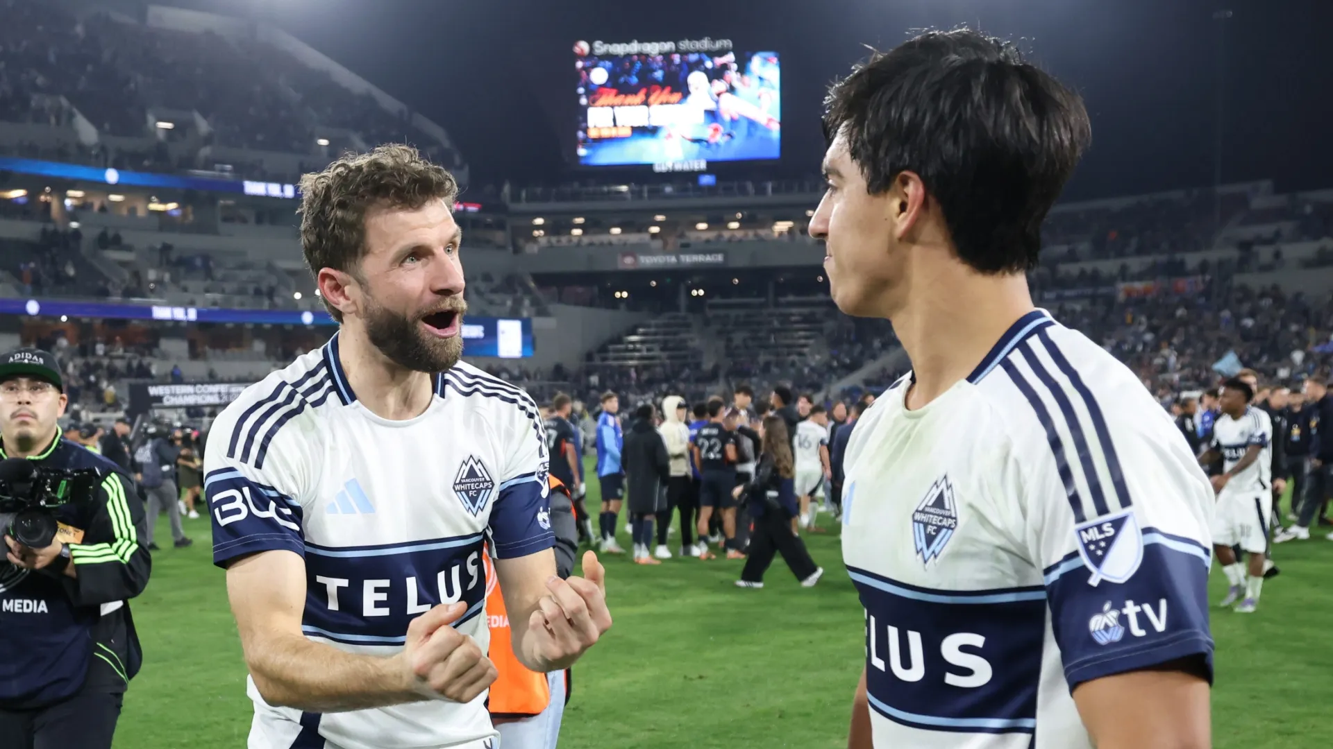Thomas Muller (left) and Mathias Laborda celebrate after a Whitecaps win.