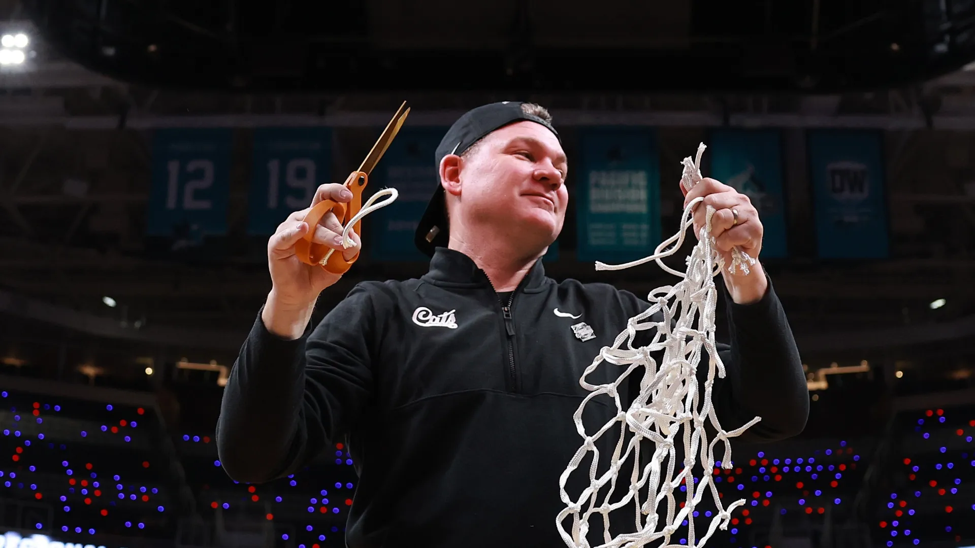 Tommy Lloyd cuts down the nets after winning Regional Tournament