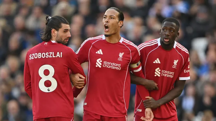 Virgil van Dijk of Liverpool lines up a wall with Dominik Szoboszlai and Ibrahima Konate