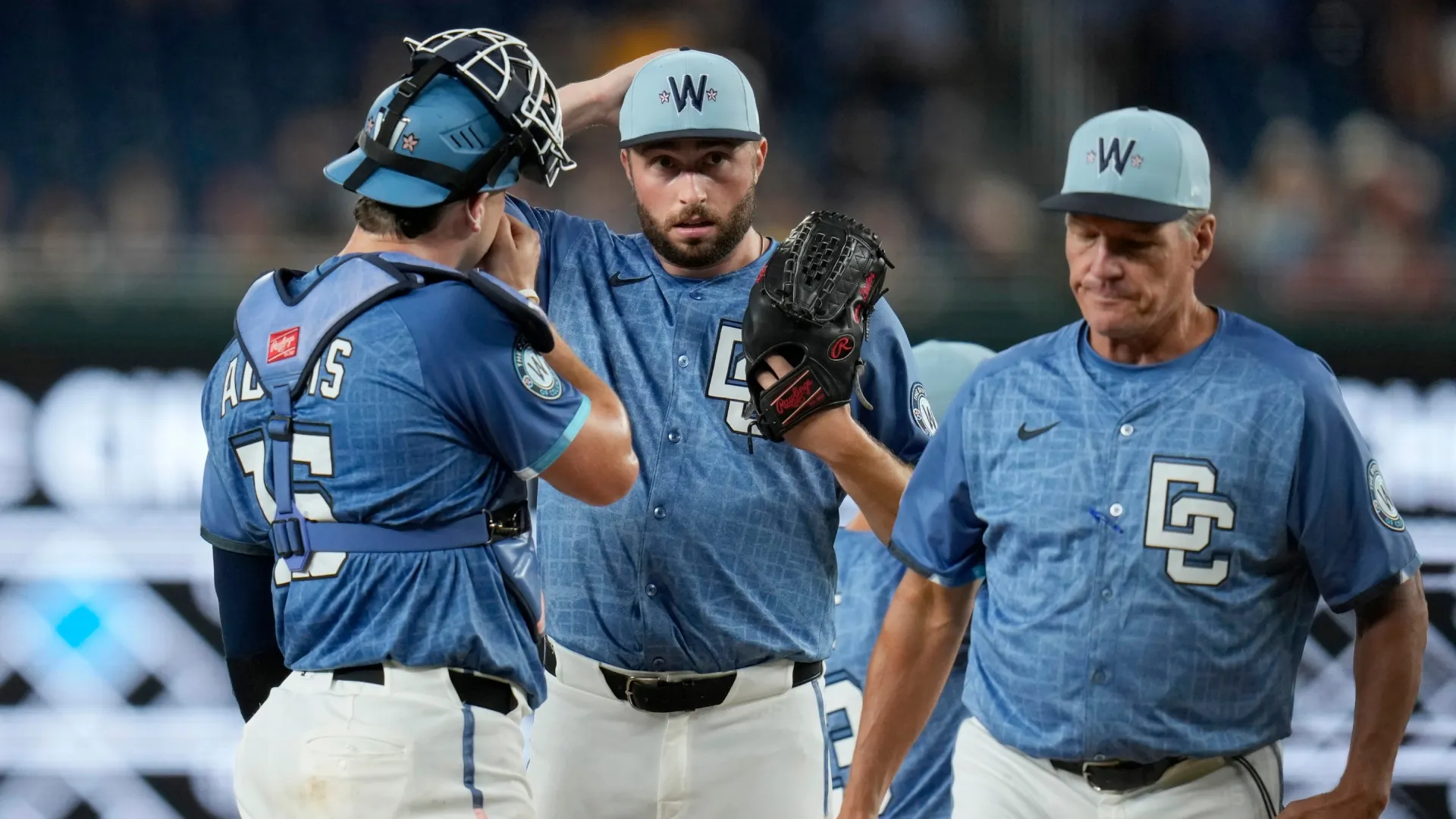 Ryan Loutos with the Nationals meets on the mound. Jess Rapfogel/Getty Images
