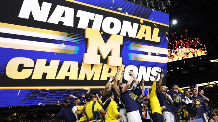 The Michigan Wolverines celebrate after defeating the UConn Huskies 69-63 in the National Championship