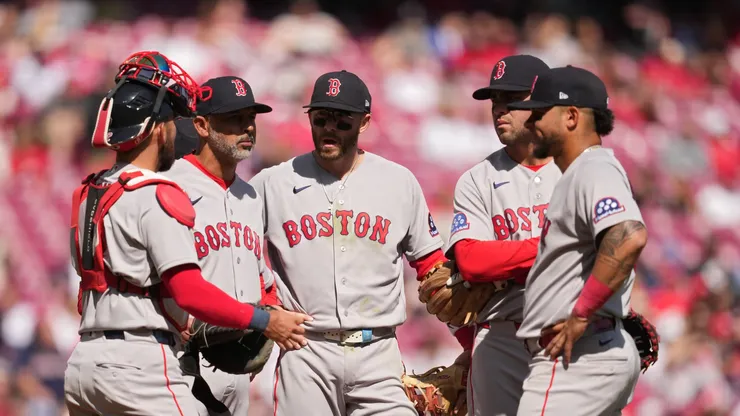 Alex Cora stands at the pitcher's mound with Red Sox players