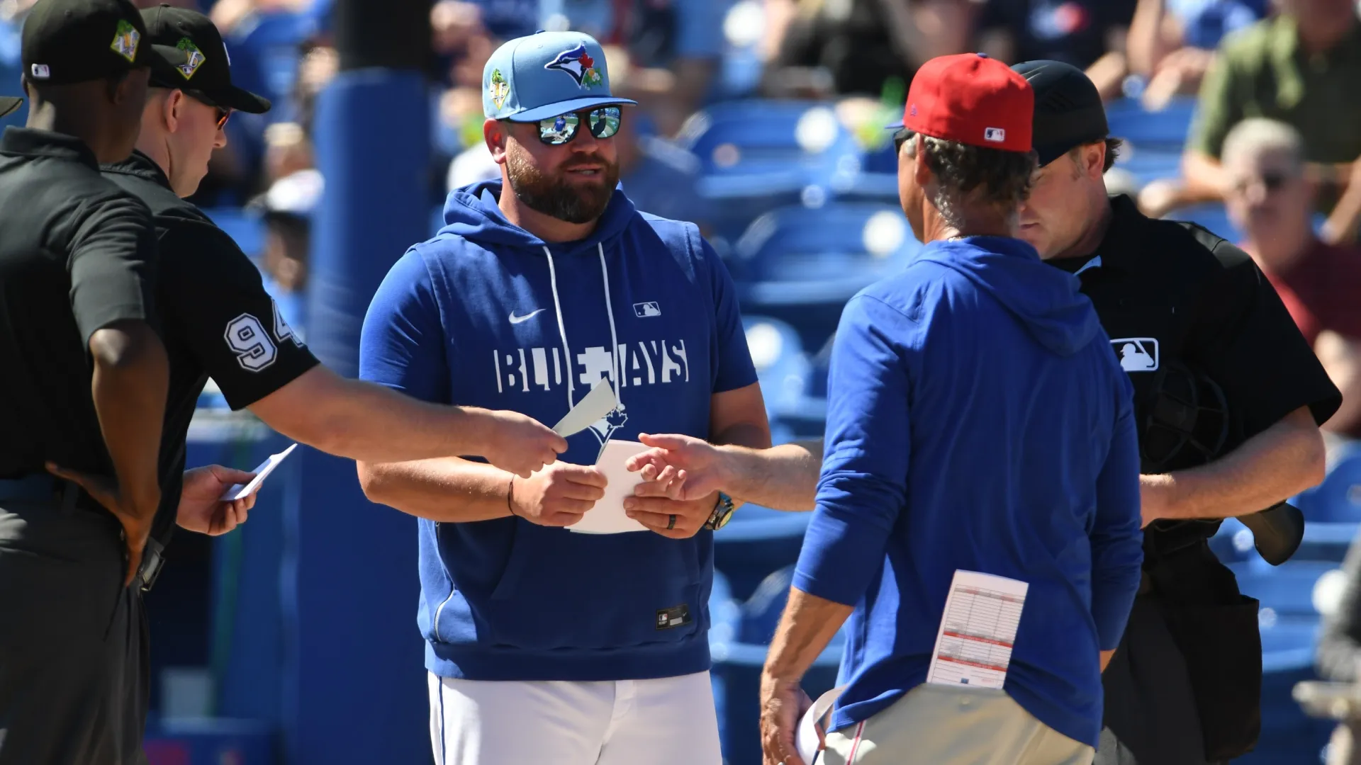 John Schneider #14 of the  Blue Jays and bench coach Don Mattingly #8 of the Phillies exchange lineups. Mark Taylor/Getty Images)