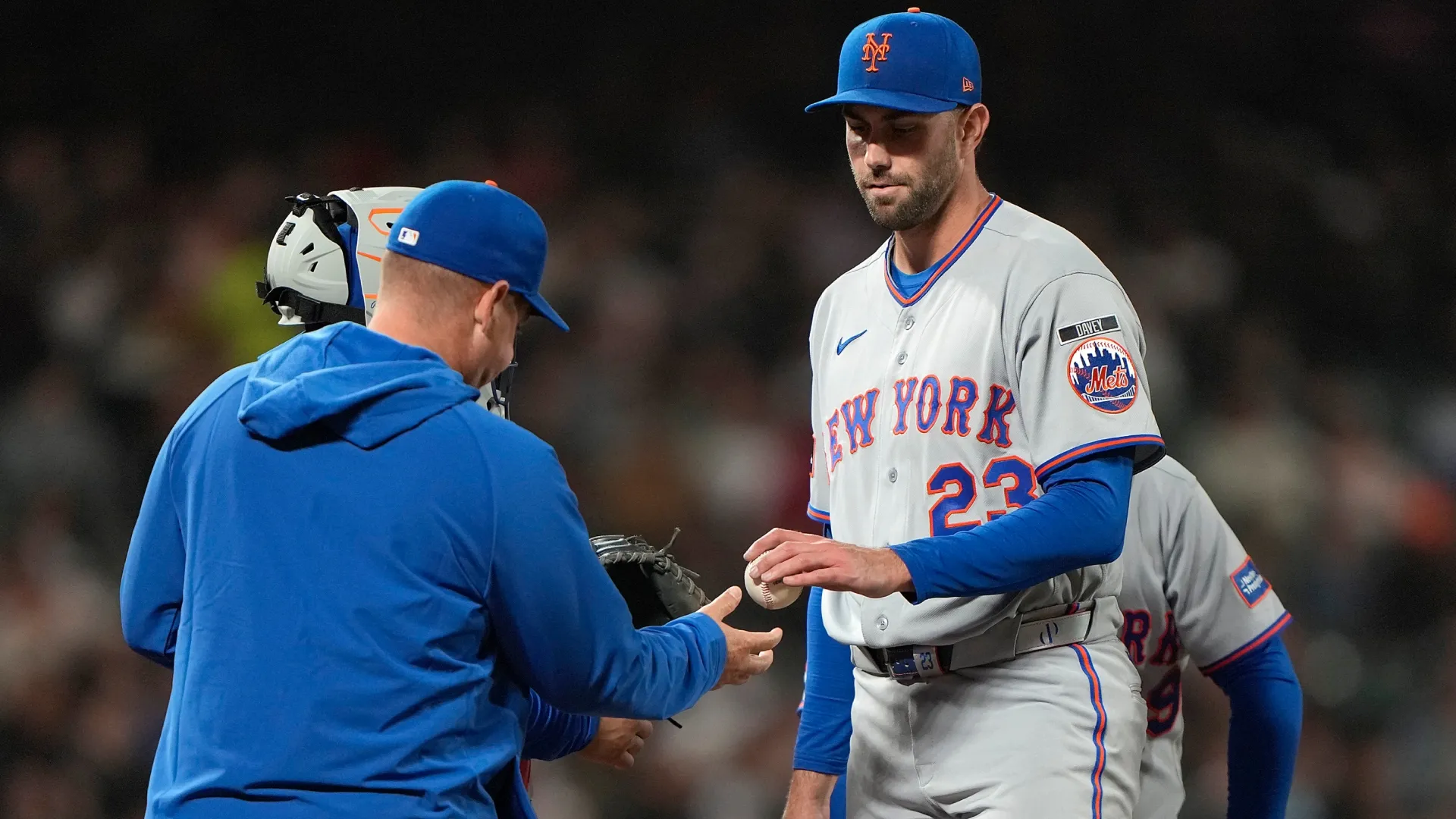 Carlos Mendoza #64 takes the ball from pitcher David Peterson #23 taking him out of the game. Thearon W. Henderson/Getty Images