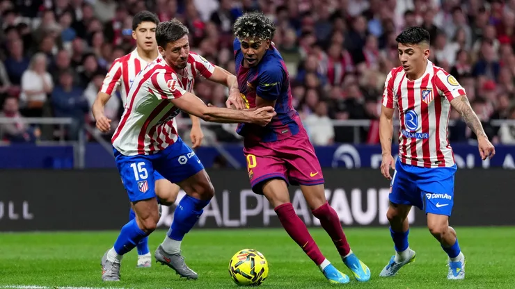 Lamine Yamal of Barcelona is challenged by Clement Lenglet of Atletico de Madrid in 2026.