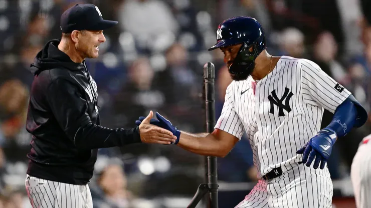 Amed Rosario #14 of the New York Yankees celebrates with manager Aaron Boone #17.
