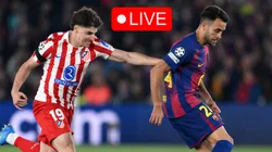 Eric Garcia of FC Barcelona runs with the ball while under pressure from Julian Alvarez of Atletico Madrid.