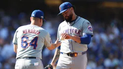 Sean Manaea #59 of the New York Mets reacts hands the ball to Carlos Mendoza #64.